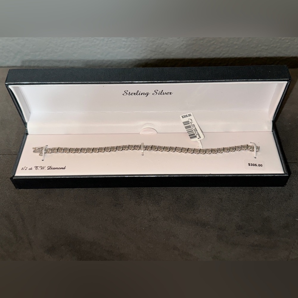 Brand new 1/2 carat diamond and sterling silver bracelet with original tag/box